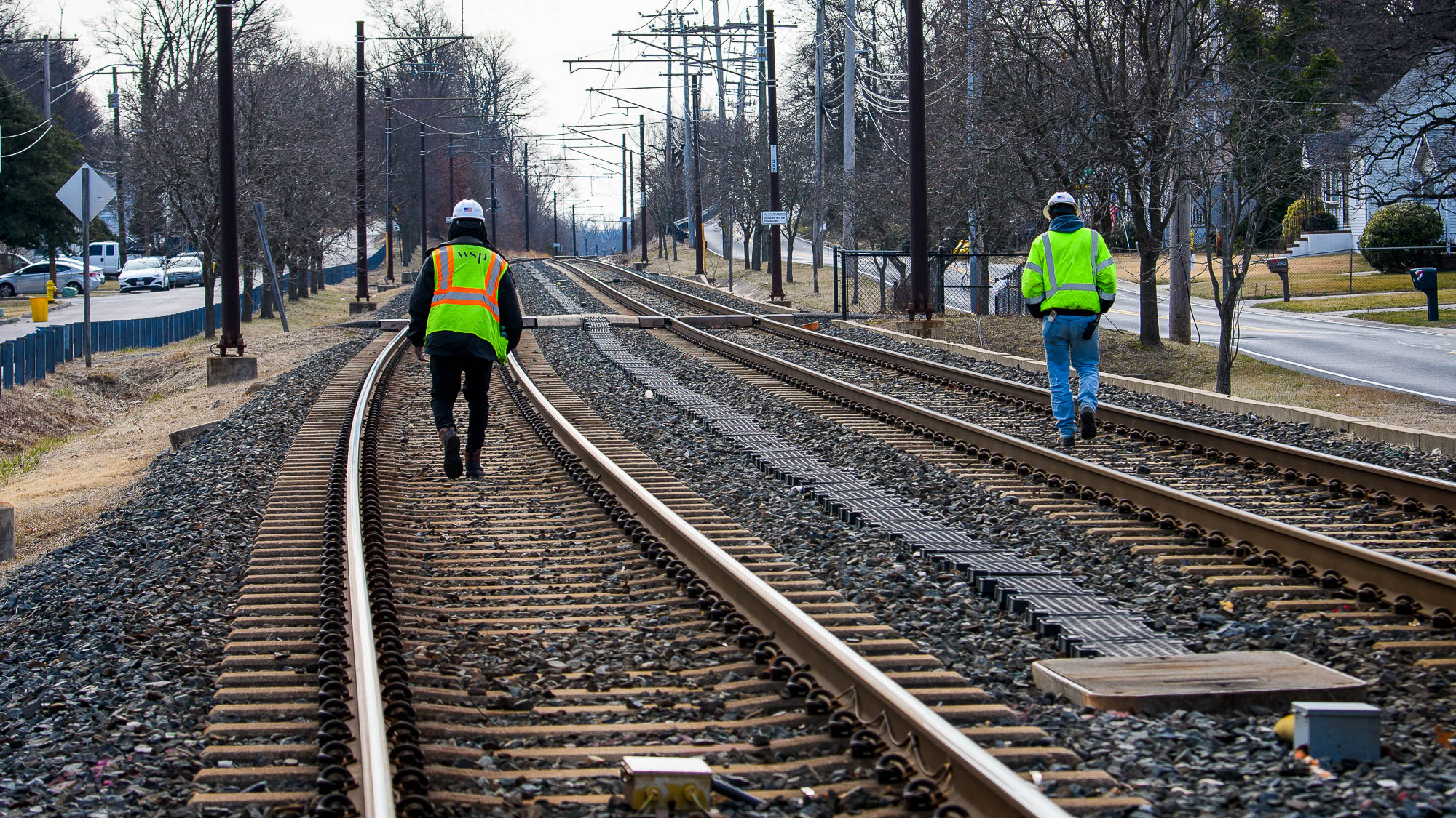 photo of transit workers inspecting tracks